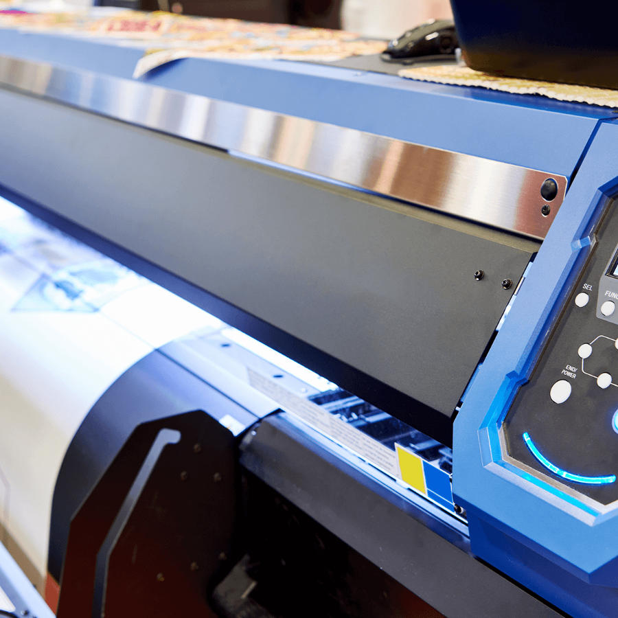 Digital transfer printer printing a design onto transfer paper.