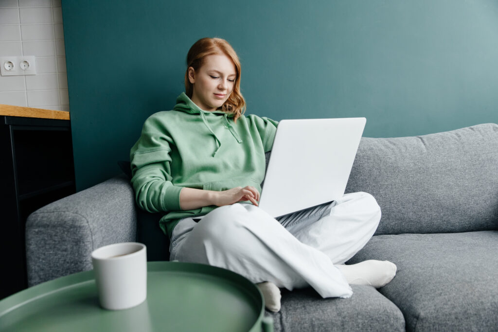 Person sat working from home on couch in loungewear.
