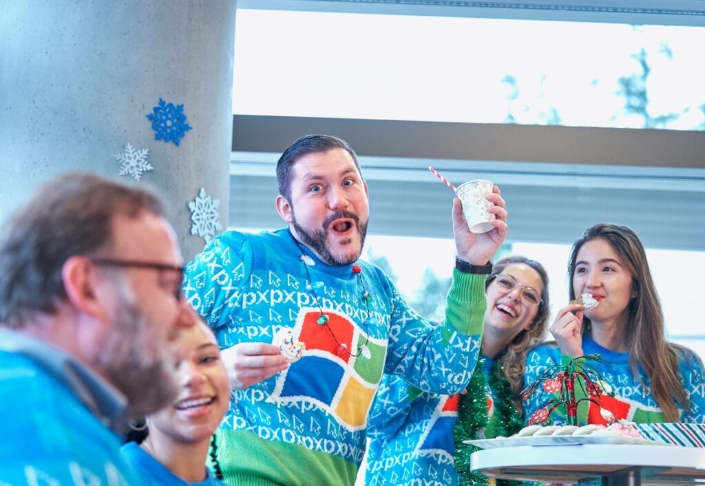 Microsoft team wearing matching branded Christmas jumpers at an office party.