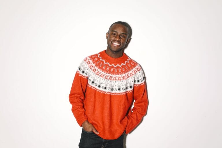 Man wearing a traditional Fair Isle Christmas jumper with a snowflake and reindeer yoke.