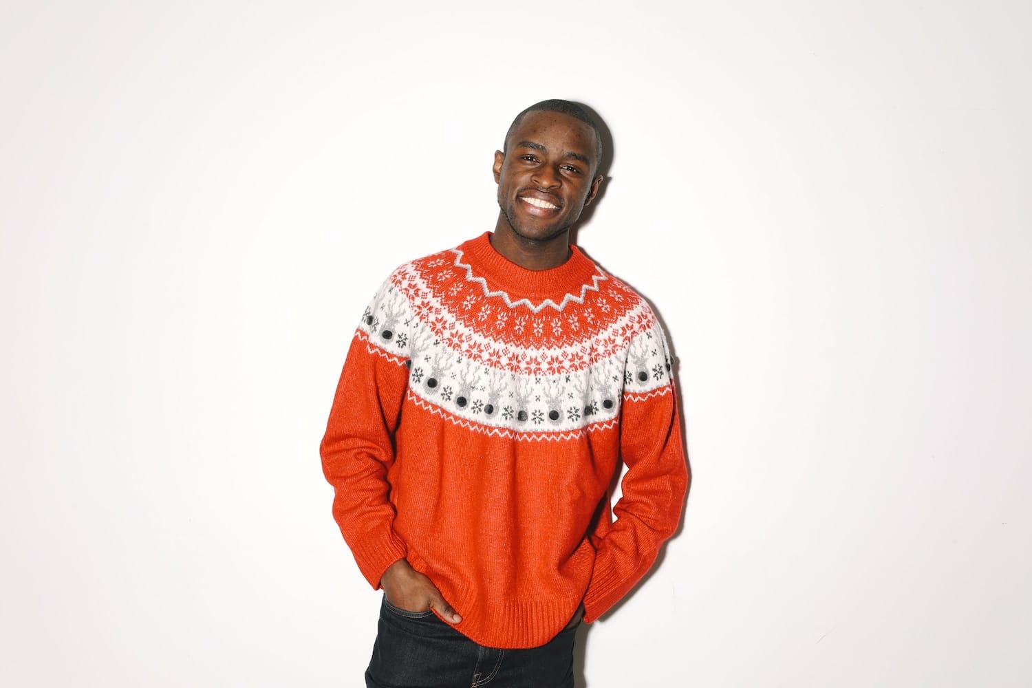 Man wearing a traditional Fair Isle Christmas jumper with a snowflake and reindeer yoke.